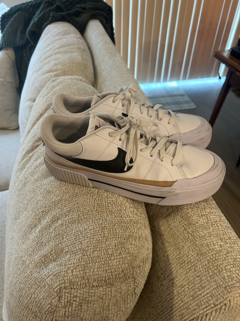 Nike White Leather Low-Top Sneakers with Black Swoosh and Gold Accent